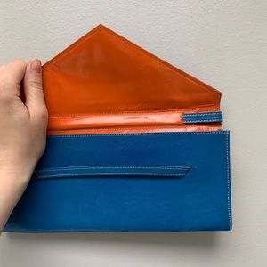 Tusk LTD. blue and orange envelop clutch